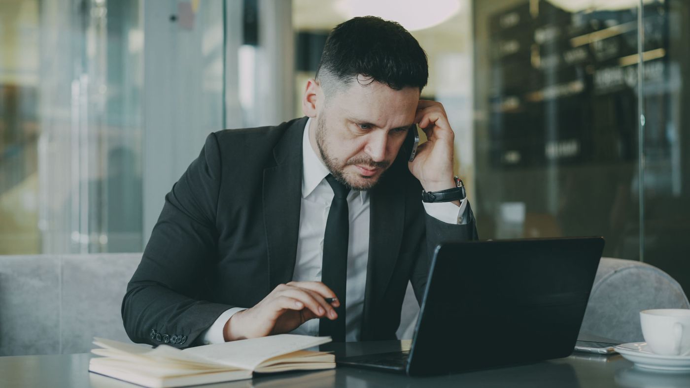 Consultant on a call reviewing numbers on a laptop