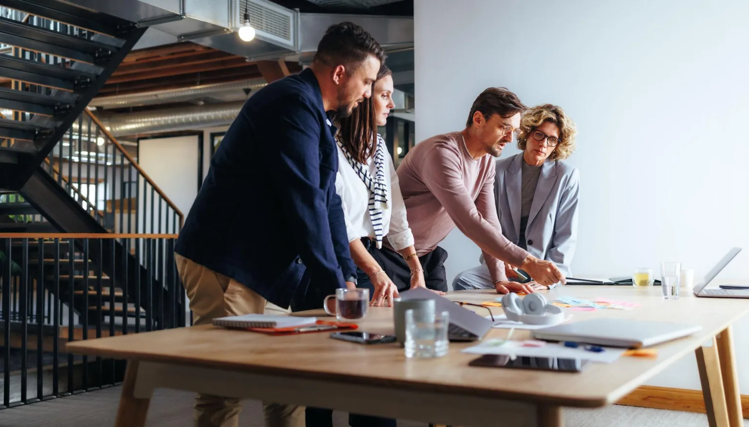 Consultants mapping a marketing strategy on a whiteboard