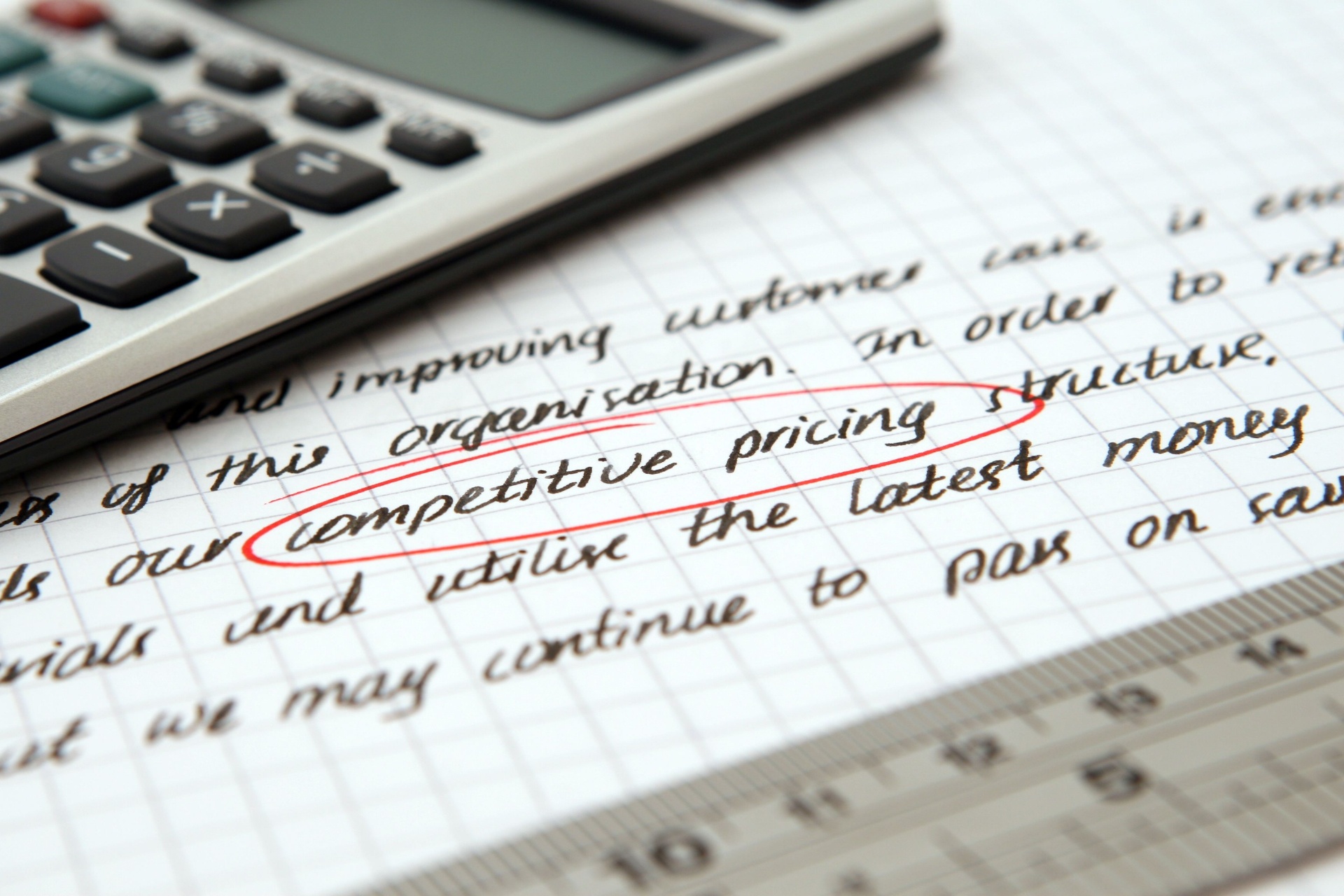 Handwritten notes with the phrase "competitive pricing structure" circled in red next to a calculator